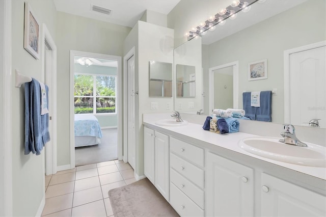 4841 Whispering Oaks Dr, North Port, FL 34287 - ensuite bathroom featuring double vanity and tile patterned floors