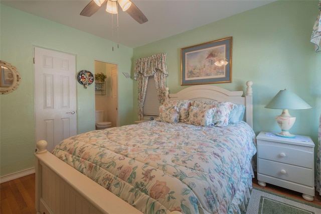 bedroom featuring connected bathroom, dark hardwood / wood-style flooring, and ceiling fan