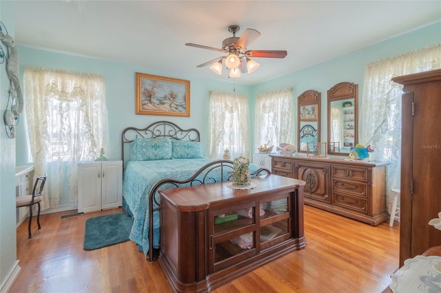 bedroom with ceiling fan and light hardwood / wood-style flooring