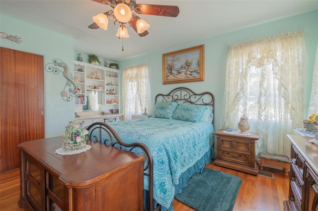 bedroom with ceiling fan and hardwood / wood-style floors