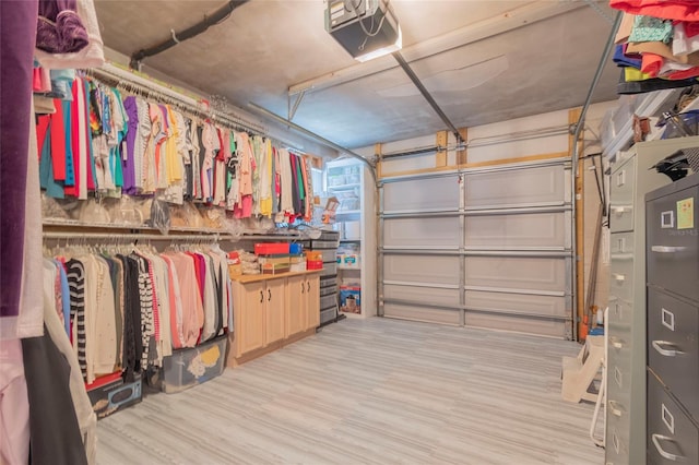 walk in closet with light hardwood / wood-style flooring