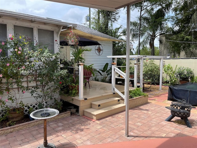 view of patio / terrace featuring a fire pit and a deck