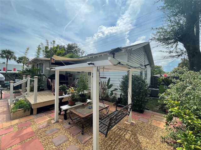 view of side of property featuring a patio and a deck