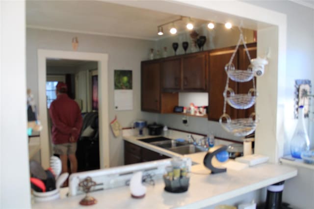 kitchen with sink, kitchen peninsula, and track lighting