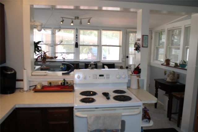 kitchen with track lighting and electric stove