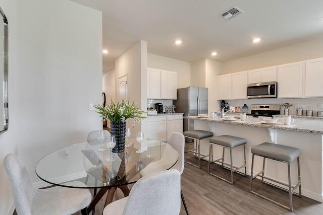 dining space with light hardwood / wood-style flooring