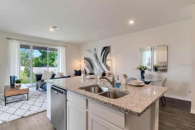 kitchen with white cabinets, dishwasher, sink, and light hardwood / wood-style flooring