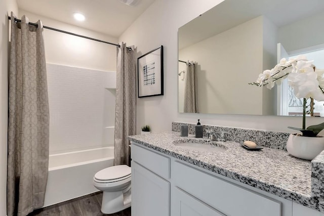 full bathroom featuring shower / tub combo, toilet, vanity, and wood-type flooring