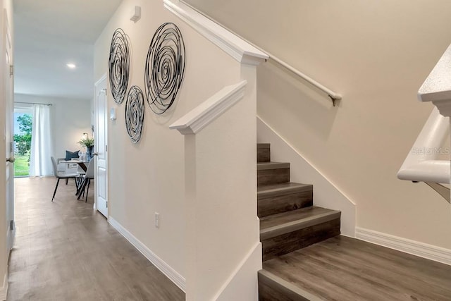 stairs featuring dark hardwood / wood-style floors