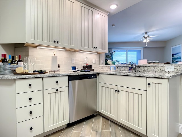 kitchen featuring ceiling fan, backsplash, dishwasher, kitchen peninsula, and light stone countertops