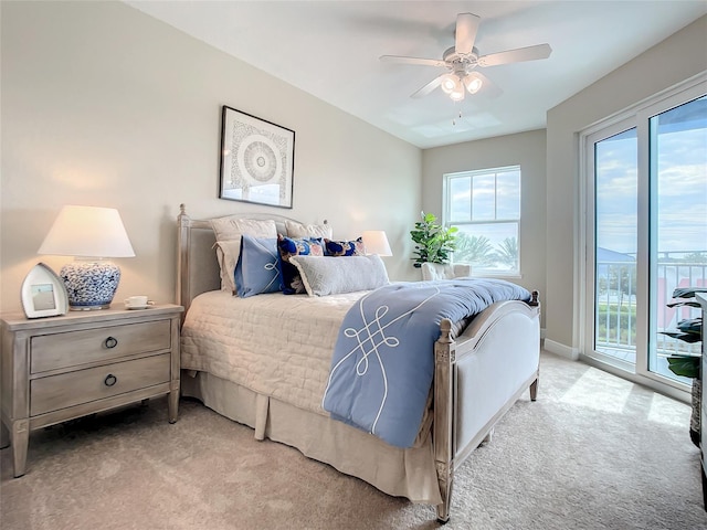 bedroom with light carpet, ceiling fan, and access to outside