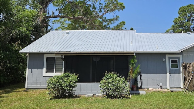 2801 Nordman Ave, New Smyrna Beach, FL 32168 - back of house with a lawn and metal roof