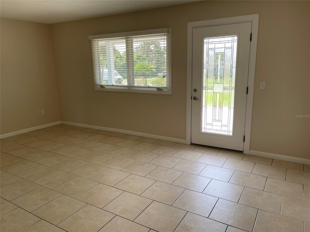 entryway featuring light tile floors and a healthy amount of sunlight