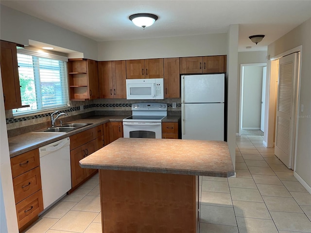 kitchen with white appliances, sink, light tile floors, a kitchen island, and backsplash