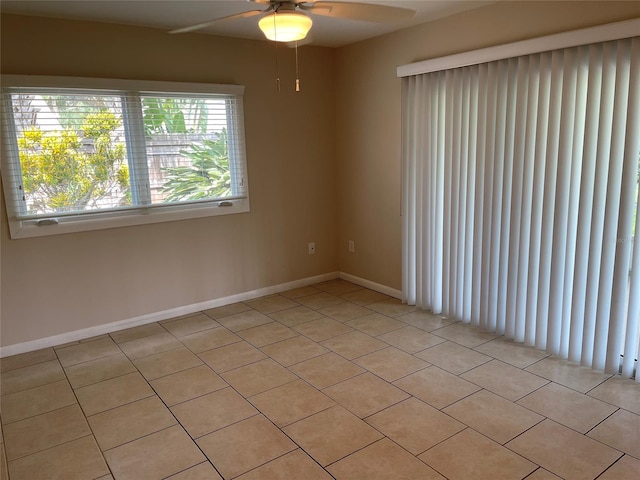 tiled spare room with ceiling fan