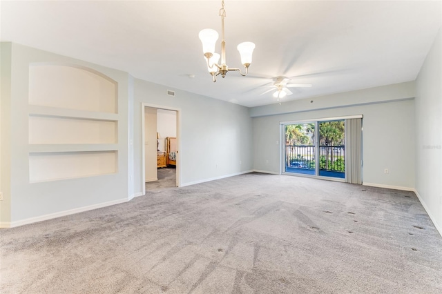 empty room with ceiling fan with notable chandelier, built in features, and carpet flooring