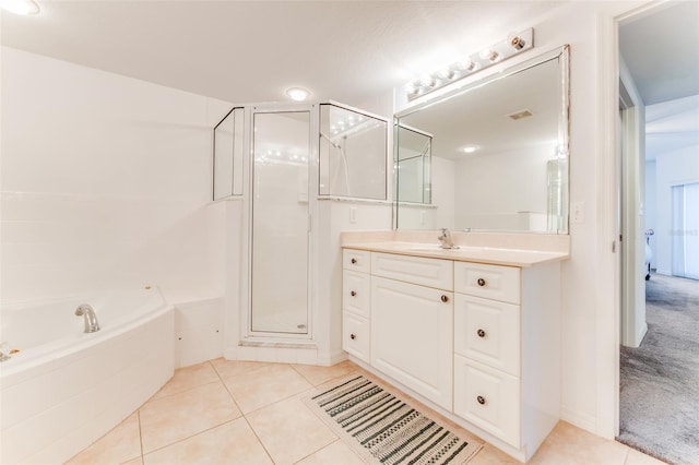 bathroom with tile patterned flooring, plus walk in shower, and vanity