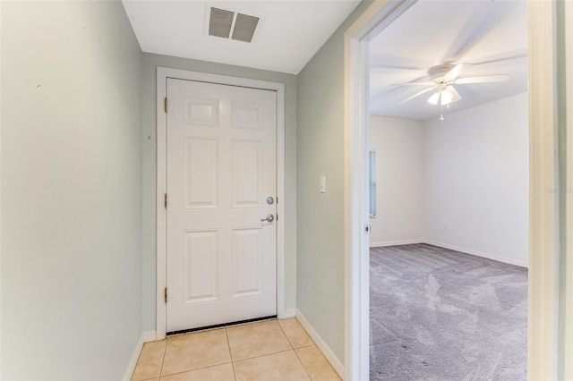 entryway featuring light tile patterned floors and ceiling fan