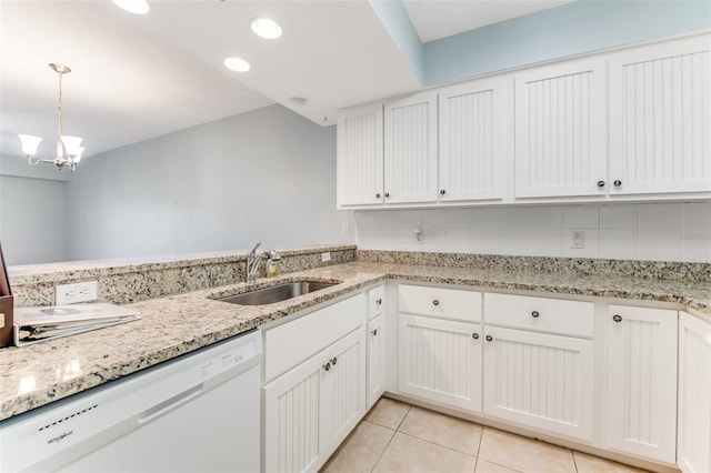 kitchen with decorative light fixtures, white cabinetry, dishwasher, sink, and light tile patterned floors