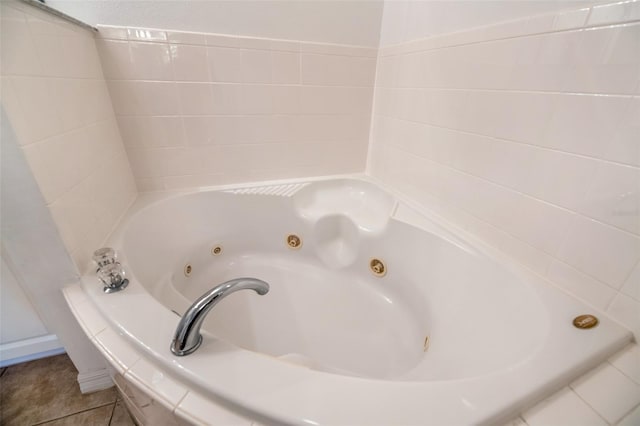 bathroom featuring tile patterned floors and tiled tub