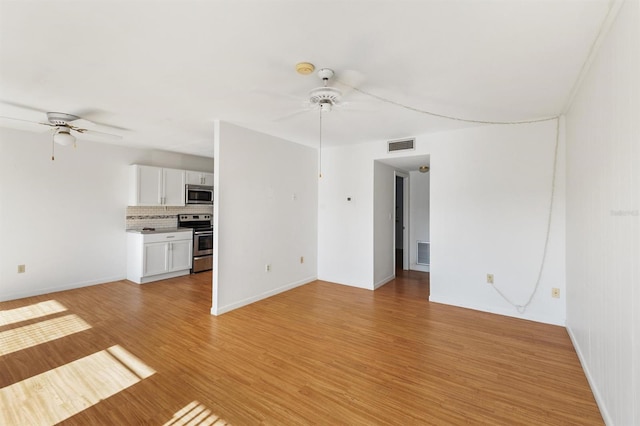 unfurnished living room with light hardwood / wood-style floors and ceiling fan