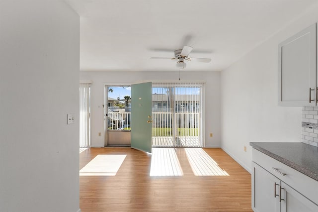 interior space with ceiling fan and light hardwood / wood-style flooring