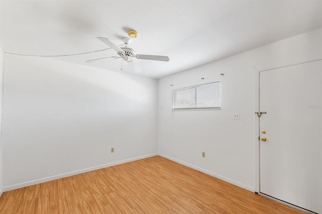 empty room with ceiling fan and light hardwood / wood-style flooring