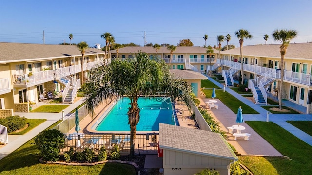 view of pool featuring a lawn and a patio area