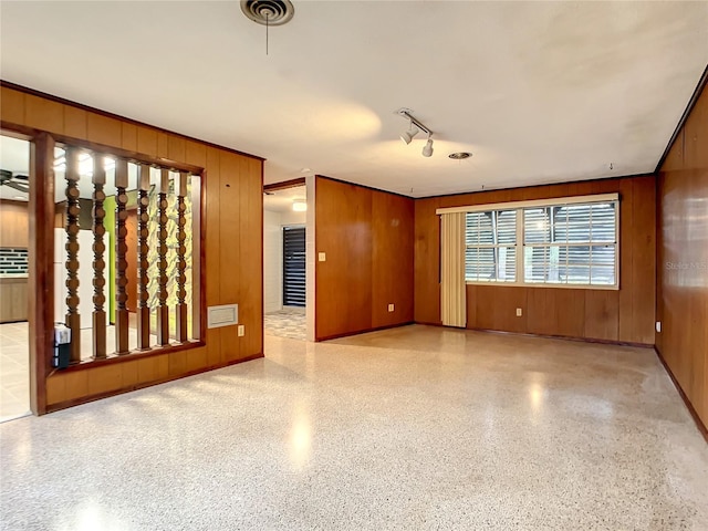 spare room with wood walls