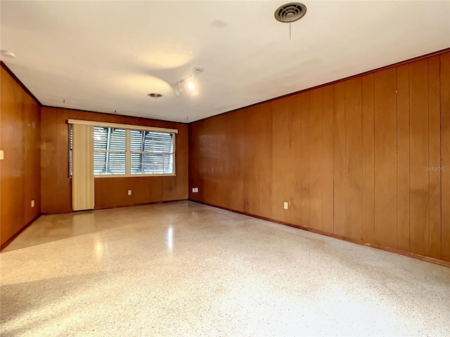 spare room with wooden walls