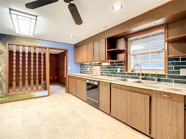 kitchen featuring ceiling fan, dishwasher, sink, and backsplash