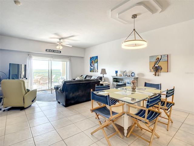 tiled dining space featuring ceiling fan