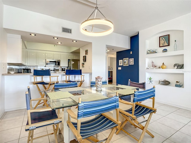 tiled dining space featuring built in features