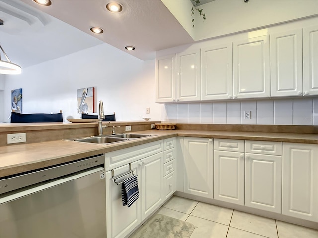 kitchen with dishwasher, backsplash, white cabinets, sink, and light tile patterned flooring