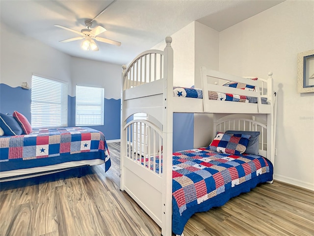 bedroom with ceiling fan and wood-type flooring