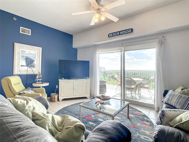 living room featuring ceiling fan and light tile patterned floors