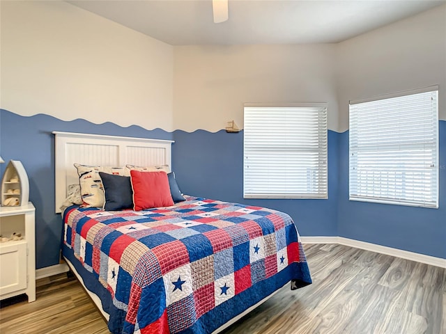 bedroom with ceiling fan and wood-type flooring