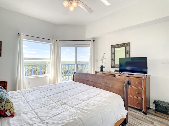 bedroom featuring ceiling fan, light wood-type flooring, and access to outside