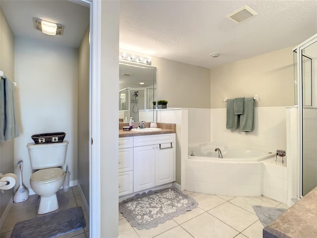 full bathroom with plus walk in shower, tile patterned flooring, a textured ceiling, toilet, and vanity