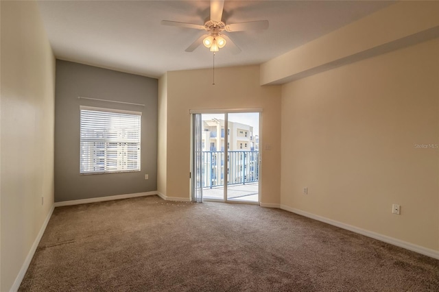 empty room with carpet floors, a wealth of natural light, and ceiling fan