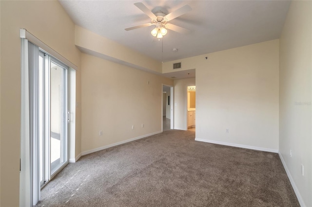 carpeted spare room featuring ceiling fan