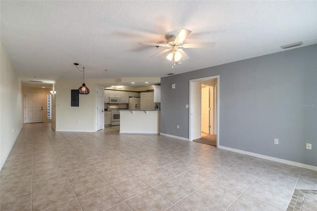 unfurnished living room with light tile patterned flooring, a textured ceiling, ceiling fan, and electric panel