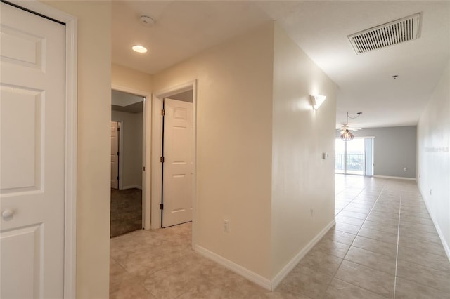 corridor with light tile patterned flooring