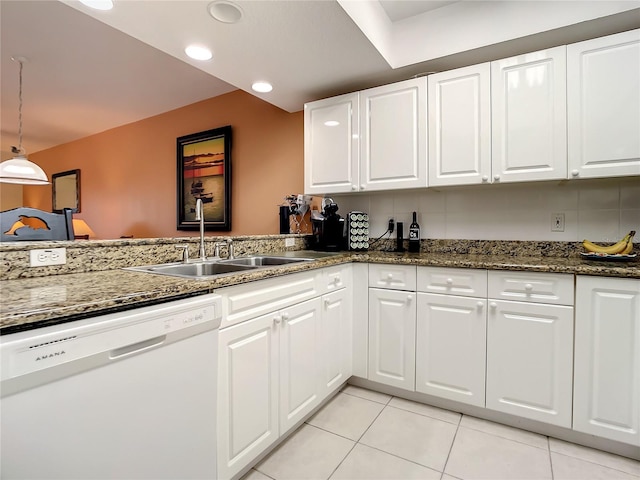 kitchen featuring light tile patterned floors, dishwasher, sink, and white cabinets