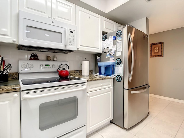 kitchen with white cabinetry, light tile patterned floors, white appliances, and backsplash