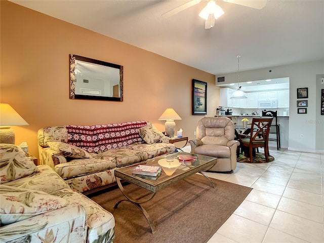 living room featuring light tile patterned floors and ceiling fan