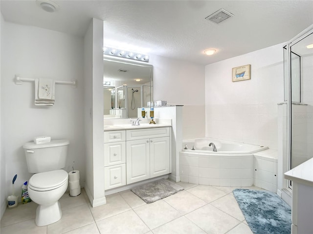 full bathroom featuring vanity, tile patterned floors, toilet, and a textured ceiling