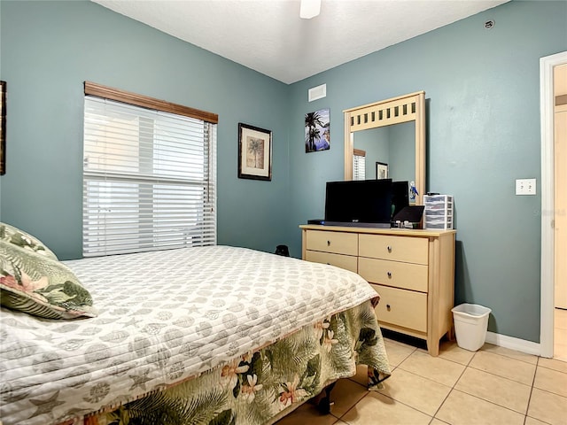 bedroom featuring light tile patterned floors and ceiling fan