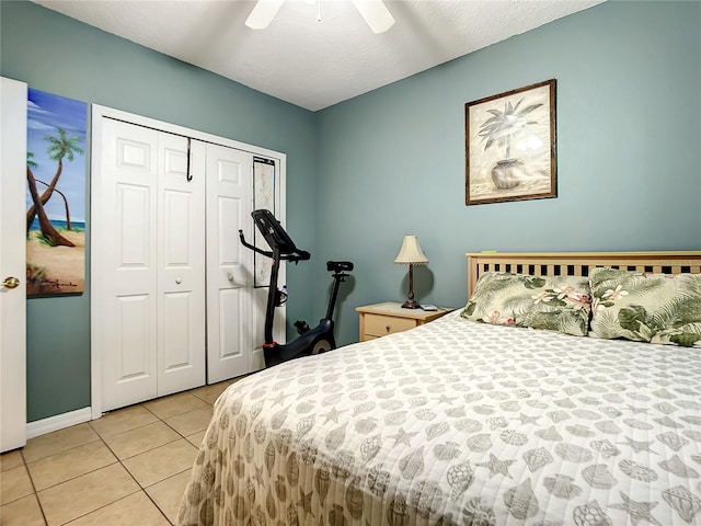 tiled bedroom featuring a textured ceiling, a closet, and ceiling fan