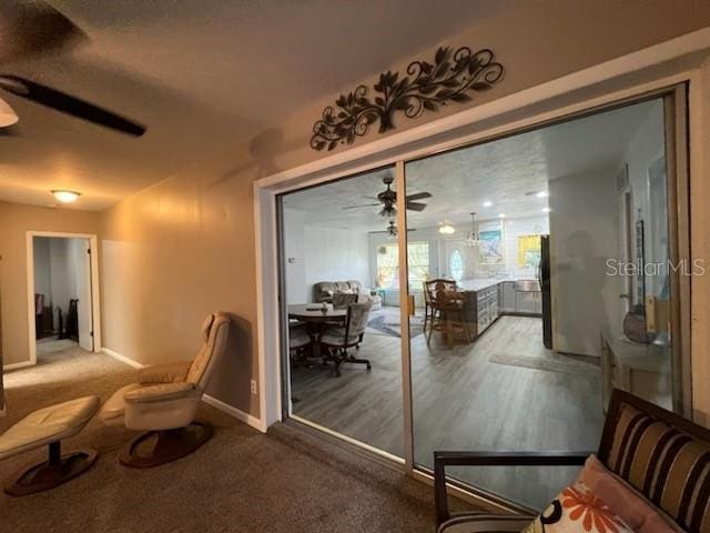 interior space featuring ceiling fan and carpet floors